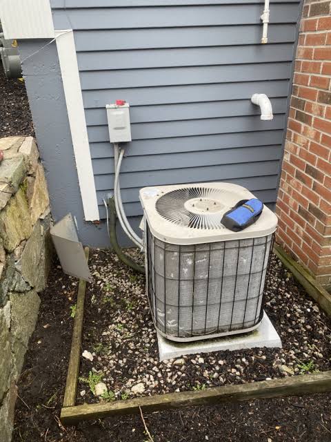 Outdoor AC condenser unit during professional HVAC inspection.