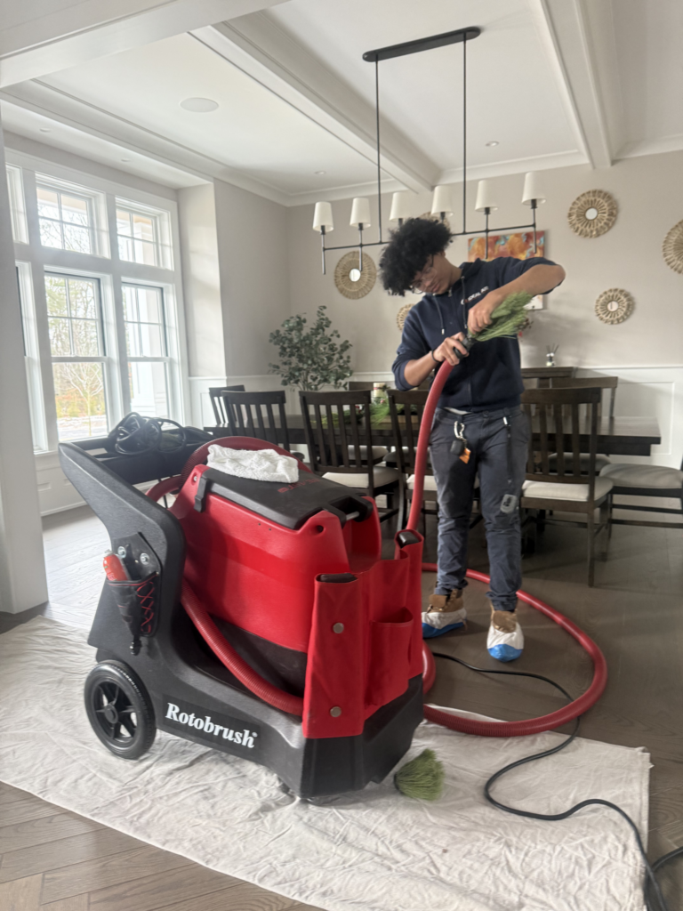 Technician performing professional air duct cleaning with Rotobrush equipment in a Framingham, MA home.